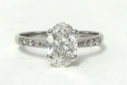 An 18ct white gold single stone ring, claw set with an oval cut stone, weighing approximately 1ct,