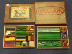 A collection including  Meccano Engineering for Boys, two trays of various wheels, cogs and parts,