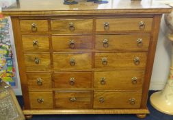 A modern mango wood chest fitted with fifteen drawers, width 115cm x 96cm height x depth 50cm