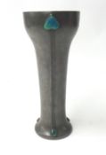 An Art Nouveau pewter vase with flared neck and inset enamelled decoration, height 26cm.