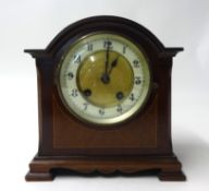 A mahogany bracket clock with striking eight day movement on a gong with pendulum, the arch top case