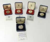 Four silver proof crowns, 1977, cased and a silver proof Charles and Diana crown, 1981, cased.