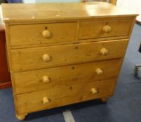 An old stripped pine chest fitted with two short and three long drawers on bun feet width 103cm.