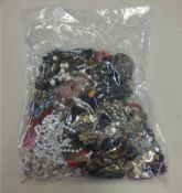 A sealed bag of costume jewellery.