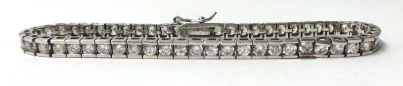 A silver and paste line bracelet, box set with brilliant cut stones.