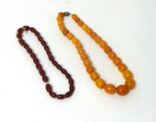 An amber style bead necklace, composed of 30 graduated beads from 14 - 10 mm, weight 28 grams and