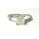 A white metal and single stone diamond ring, claw set with a Princess cut stone of approximately 0.