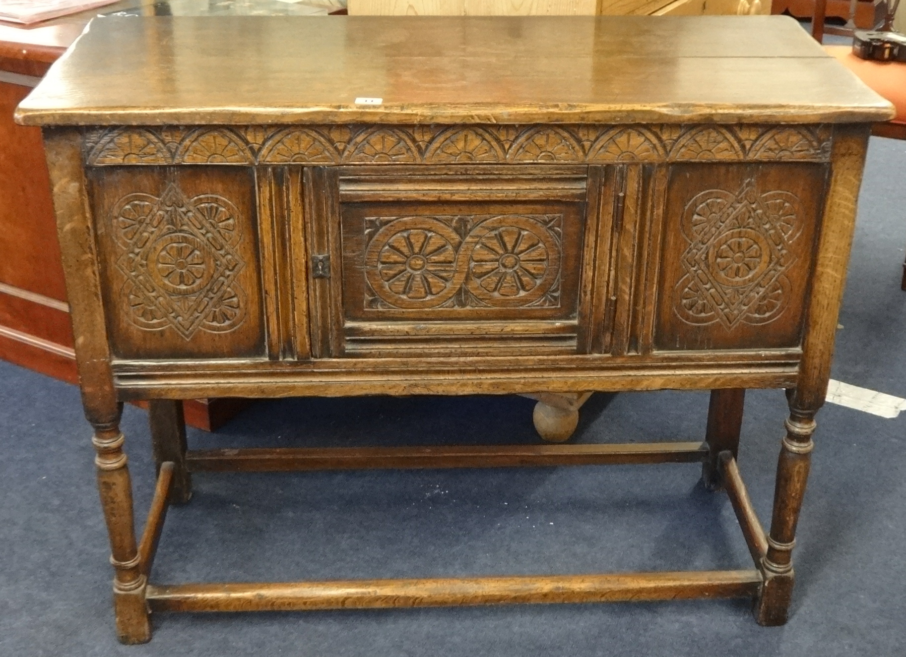 A reproduction 'stressed' oak sideboard, width 106cm.