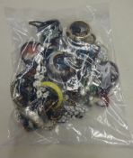 A sealed bag of costume jewellery.