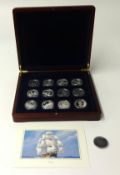 A silver proof set of 12 Trafalgar $1 dollar coins, 2007, cased and a piece of HMS Victory.