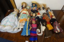 A collection of 14 porcelain headed dolls in National Costumes, height 20cm and a larger example