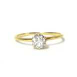 A gold single stone diamond ring, claw set with an old cut stone weighing approximately 0.50cts,