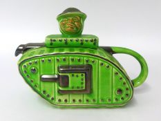 A novelty tea pot in the form of a WW I tank with Bruce Bairnsfather finial.