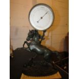 19th century aneroid barometer supported on a spelter figure of a rearing horse and dog, the base