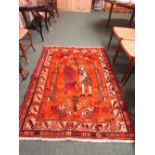 A modern Eastern-style rug of orange ground and patterned with man and lion and lions and prey (