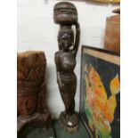 Carved dark wood statue of woman in sari carrying fruit pot on head (height 113cm)