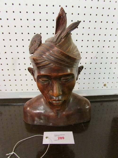 Carved hard wood bust of  male in Malaysian headdress (height 18cm)