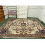 A modern fawn ground rug of four margins with floral motif and decoration (approximately 3.7m x 3.