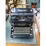 An Imperial 50 typewriter, glazed panels to sides, with original dust cover