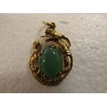 18ct gold pendant formed as a dragon cradling polished green stone (overall 3cm x 2cm approx), 7.3g