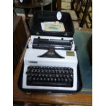 Erika 105 manual typewriter, pale grey plastic casing, Norbrit retailer's label, with instructions