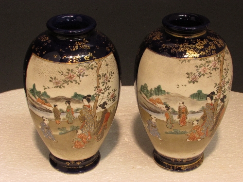 Pair of blue ground ovoid Satsuma vases each with two panels enamelled with figures in landscapes,