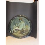 European ceramic wall plate in dark green glaze and moulded in high relief with Classical woman