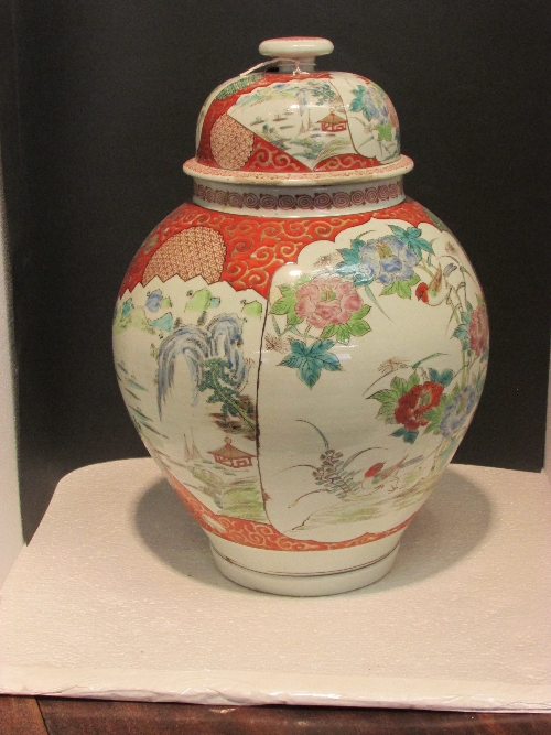 Kutani style baluster vase and cover, painted with panels of flowers and landscapes against scrolled