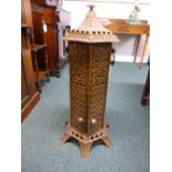 A Victorian iron stove finished in treacle brown enamel with internal spirit burning fittings within