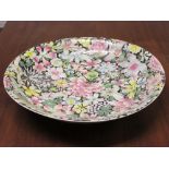 Large Chinese porcelain dish enamelled in the famille rose palette against a black ground with