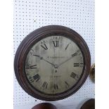 A Victorian circular mahogany framed wall clock by Underwood of London. The silvered dial has a