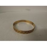 9ct gold bangle, engraved with square facets, clip fastening, British assay marks, stamped PAT No