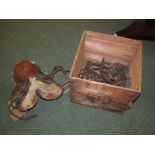 Leather saddle, stirrups, bridles and tack in a Ceylon tea box