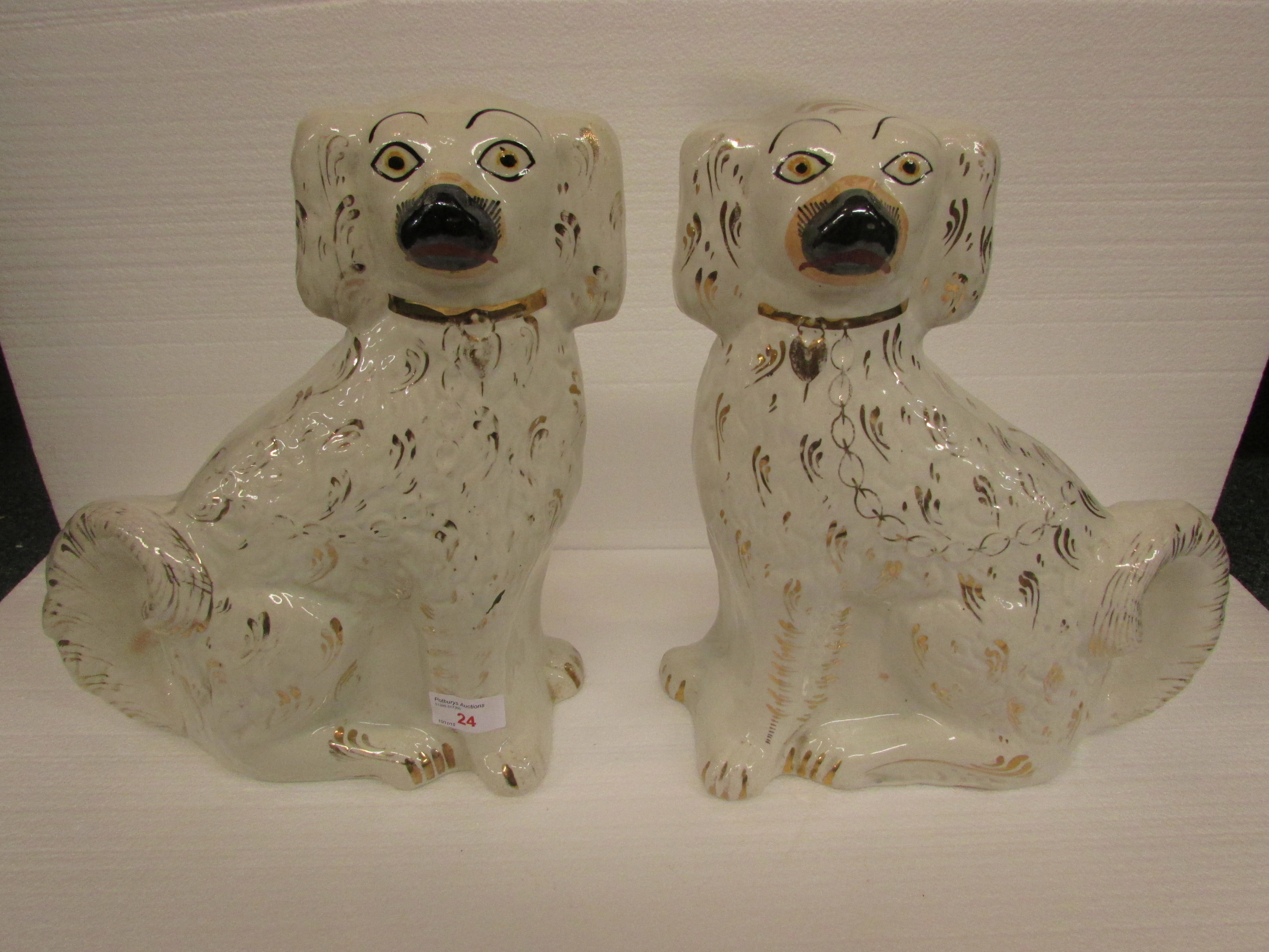 A pair of white and gilt Staffordshire dogs (32cm high)