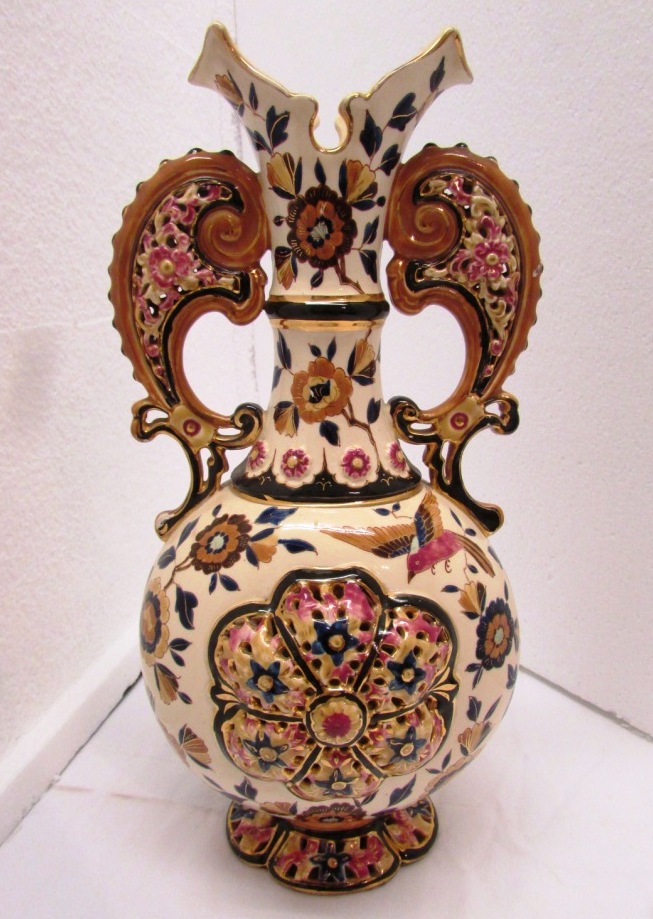 Zsolnay style vase, cream ground decorated with flowers and birds, scrolls handles to neck and