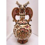 Zsolnay style vase, cream ground decorated with flowers and birds, scrolls handles to neck and