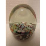 Ovoid paperweight with broad cog canes to the base and clear top, flat underside, height 7cm,