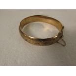 9ct gold half-engraved bangle with safety chain, British assay marks, 15.5g