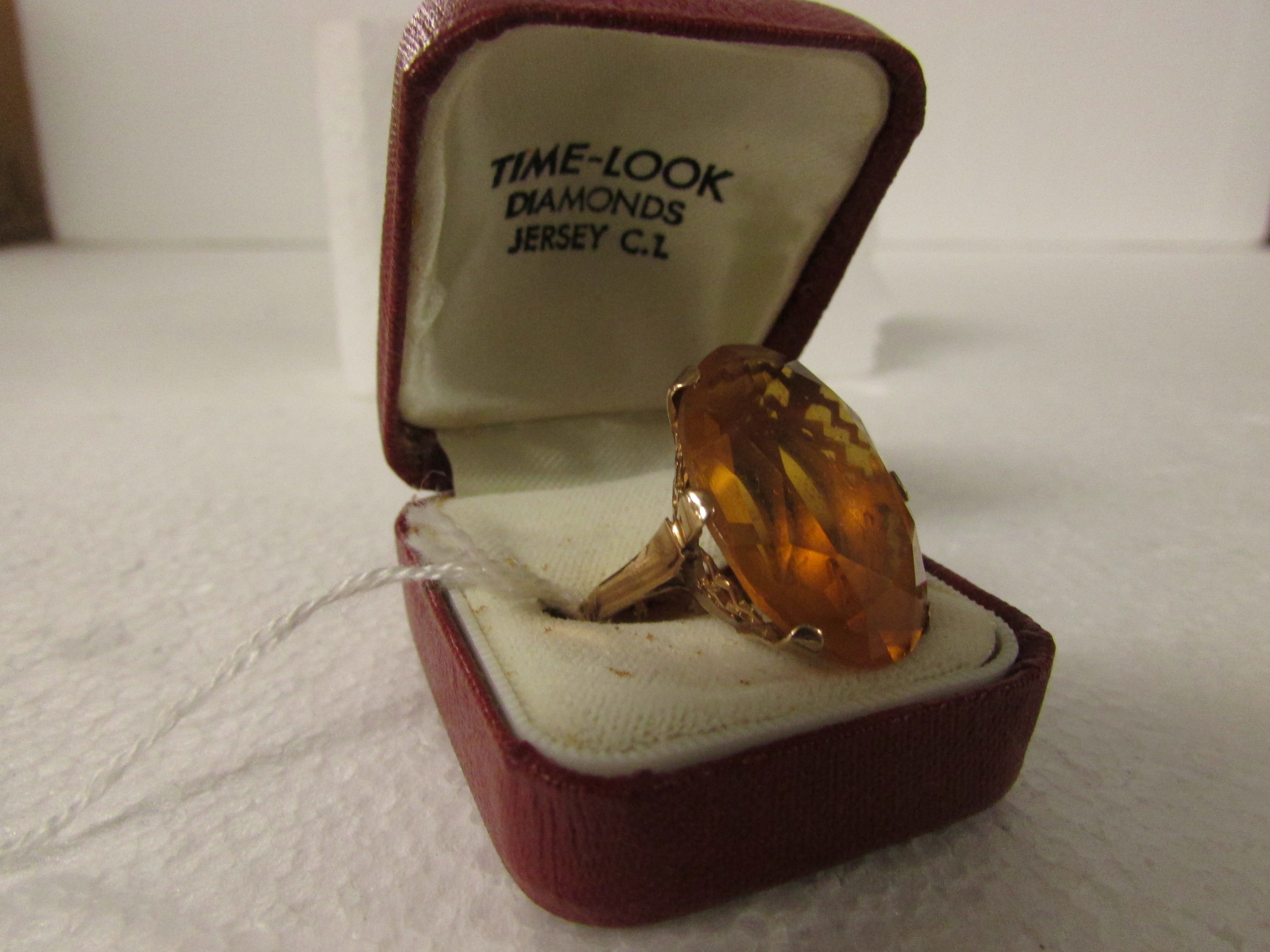 9ct gold dress ring set with a large oval cut tangerine colour stone (25mm x 18mm approx)