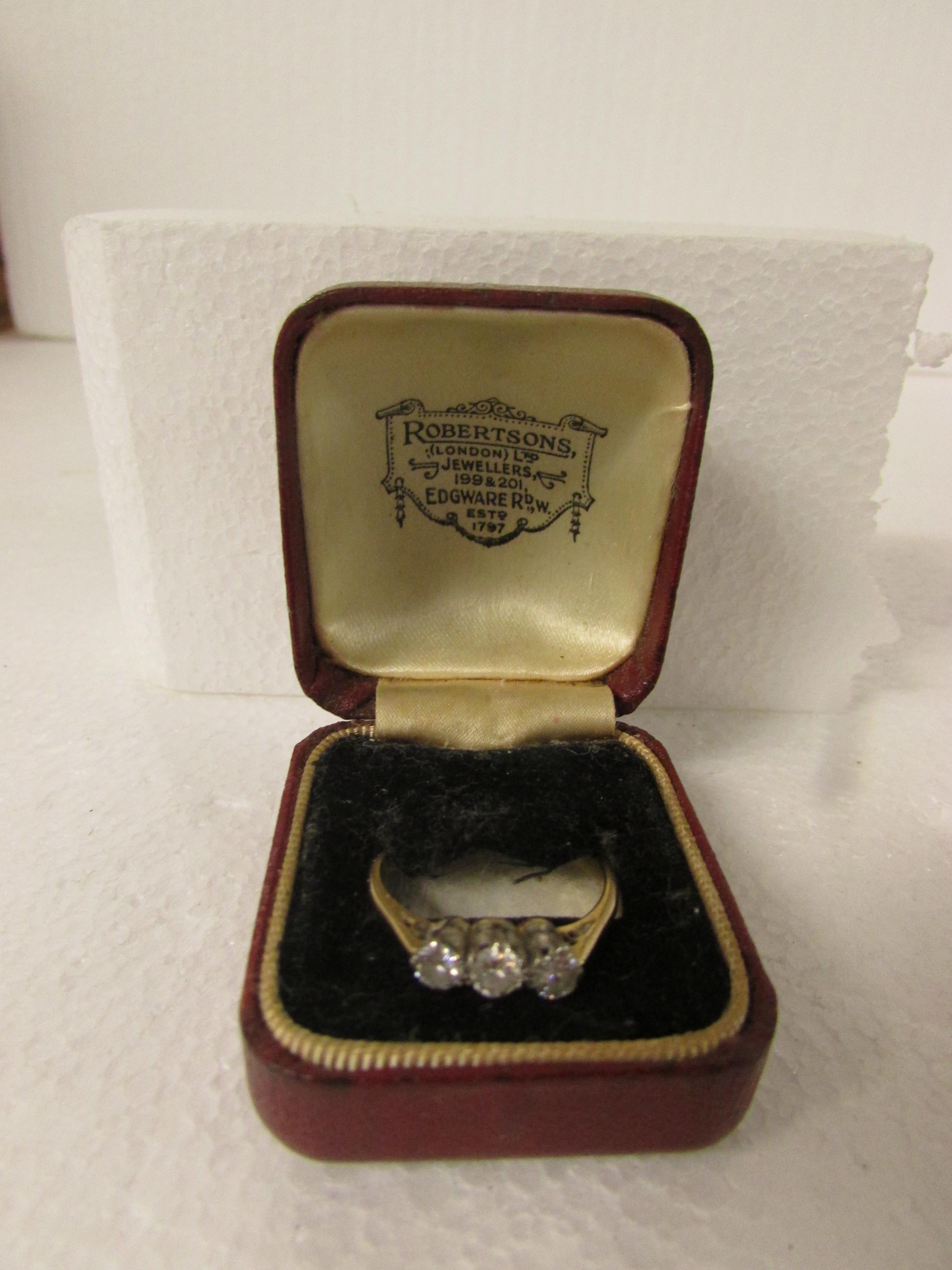 Three stone diamond engagement ring on 18ct gold shank with platinum setting, largest stone