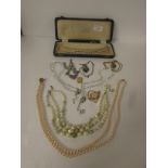 A box of assorted dress jewellery consisting of marcasite necklace, 9ct gold engraved oblong locket,