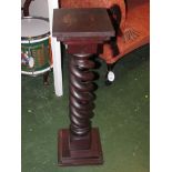 A stained mahogany plant pedestal with open double spiral column, square base and top (height 86cm)