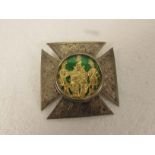 Cruciate white metal Masonic brooch set with a glazed circular emblem of gilded figures flanking