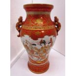 A Japanese porcelain baluster vase moulded with two dogs at the shoulder, red ground and gilding,