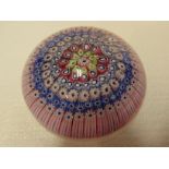 Paperweight with concentric bands of pink and blue canes, letter cane f, indented underside,