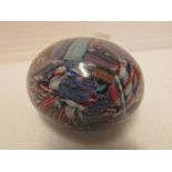 Small 'end of day' type paperweight closely packed with various twist canes predominantly in reds