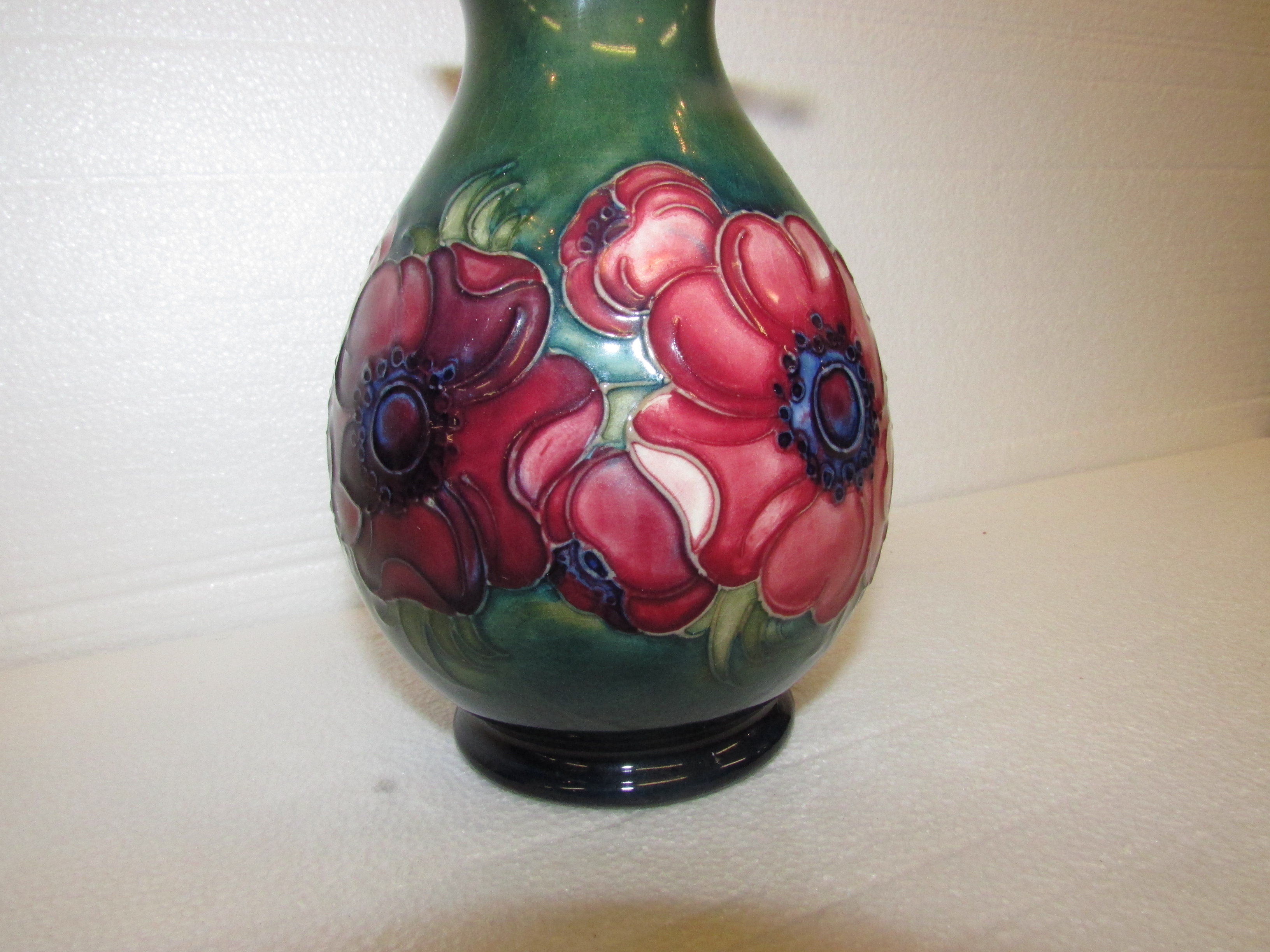 An initialled pinch necked ovoid Moorcroft vase decorated with anemone on green ground, W.A. - Image 2 of 4