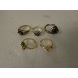 FIVE DRESS RINGS - floral spray set with three pale green stones and thirteen seed pearls on