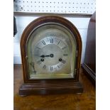 An Edwardian mahogany boxwood strung dome shaped striking mantle clock with silvered minute Roman