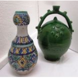 A Moroccan pottery puzzle type wine vessel in dark green glaze (height 23.5cm) and a Moroccan